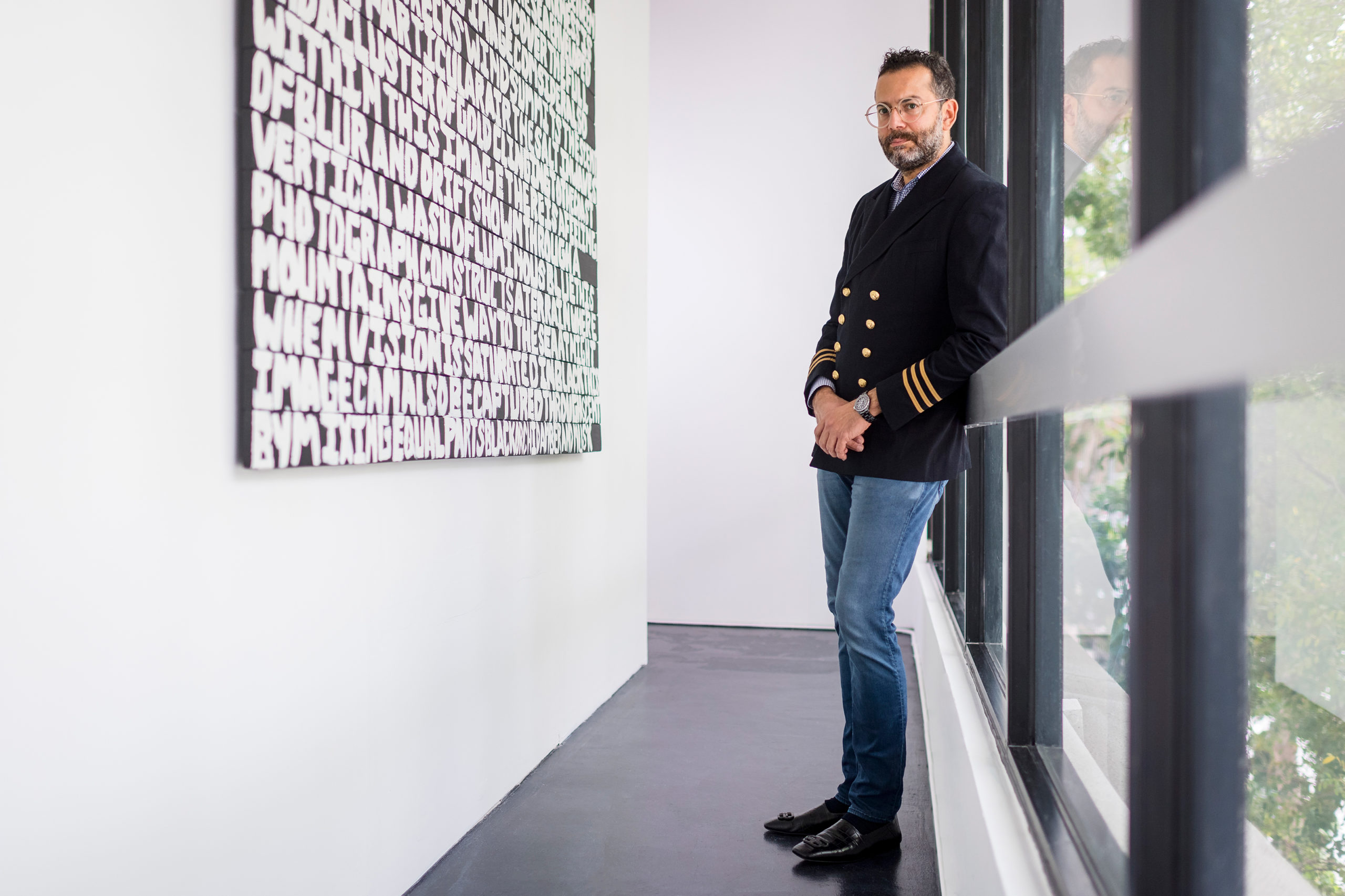 David Castillo standing in front of a typographic art piece