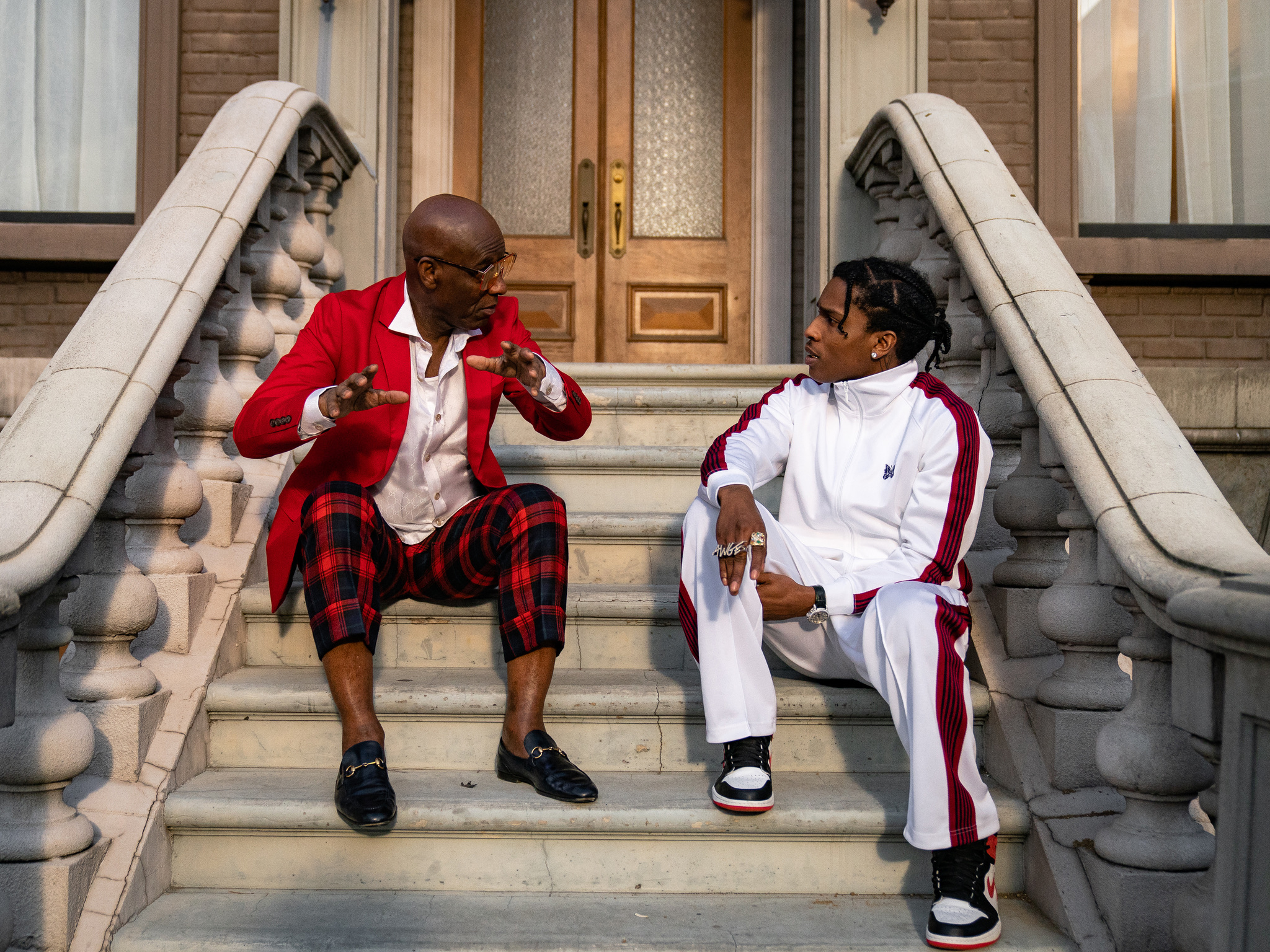 Dapper Dan and A$AP Rocky sit on Dap’s brownstone stoop
