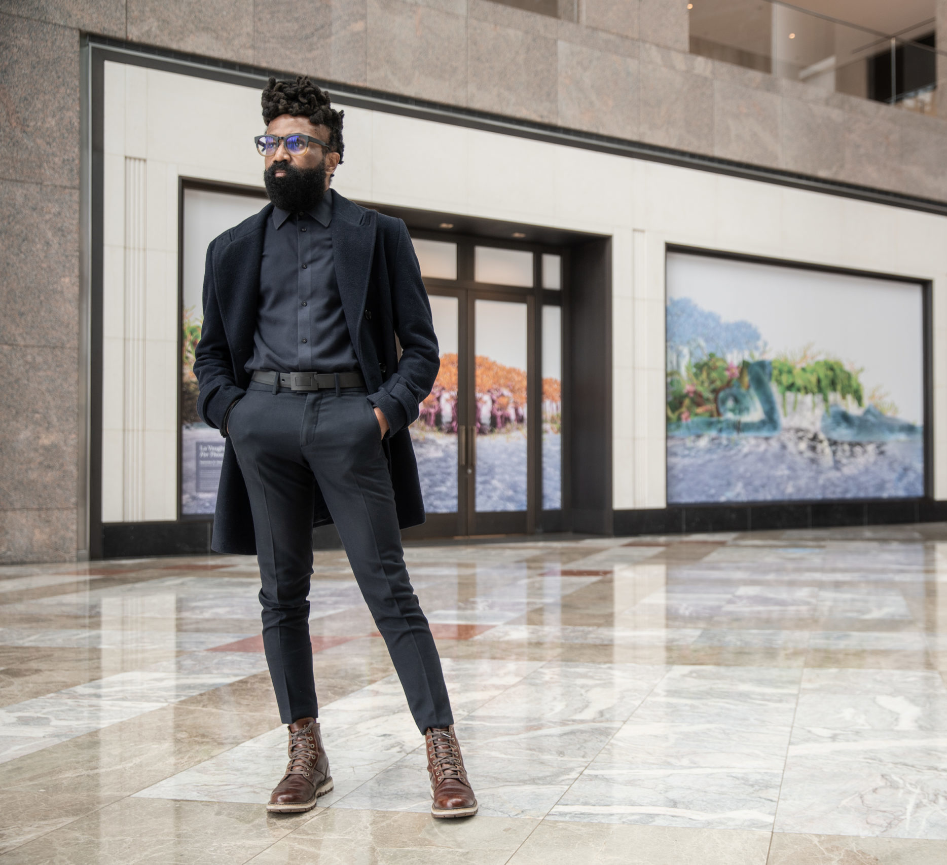 Kendal Henry stands in front of his curated piece in Brookfield Place NY
