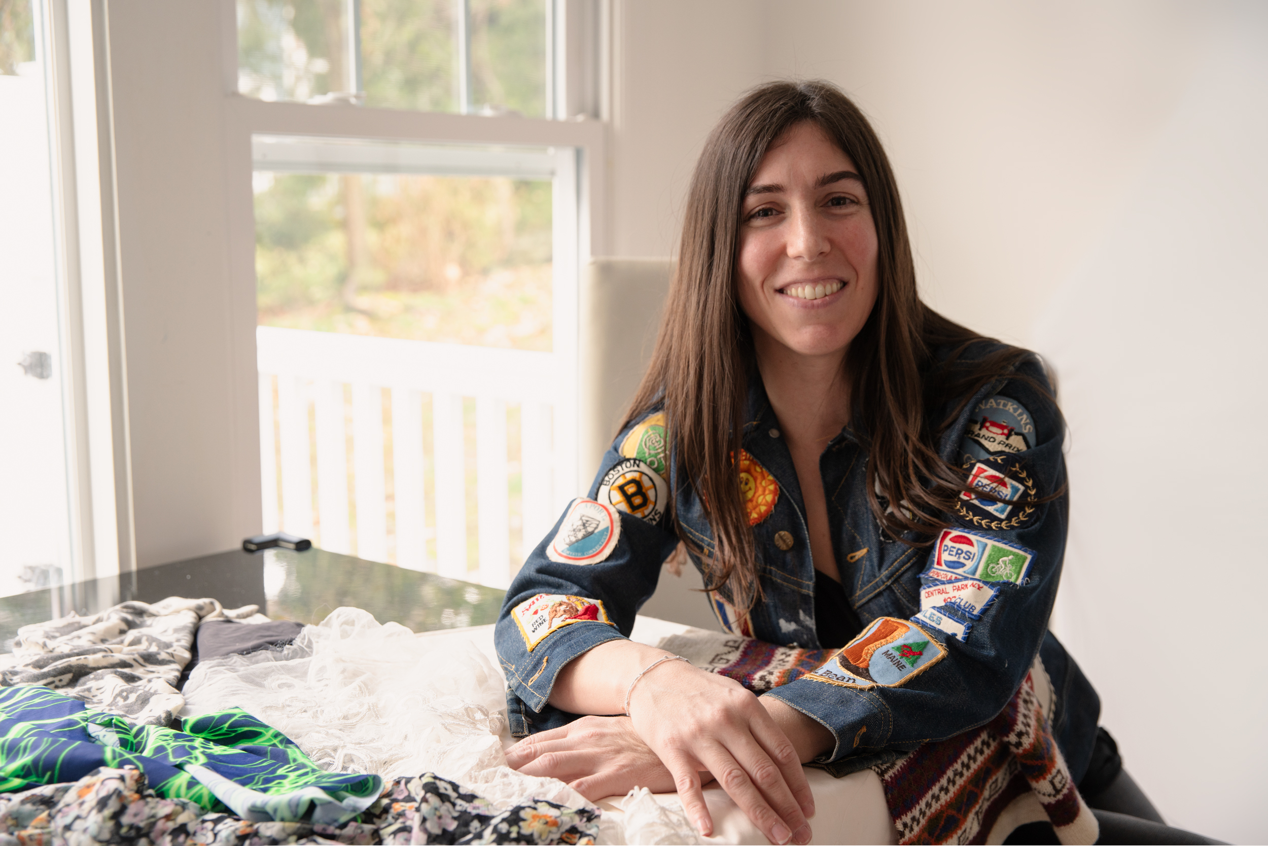 Stephanie Benedetto sits in her home with fabric